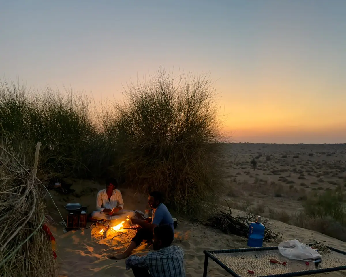 Safari crew cooking at dusk in the Thar desert near Jaisalmer
