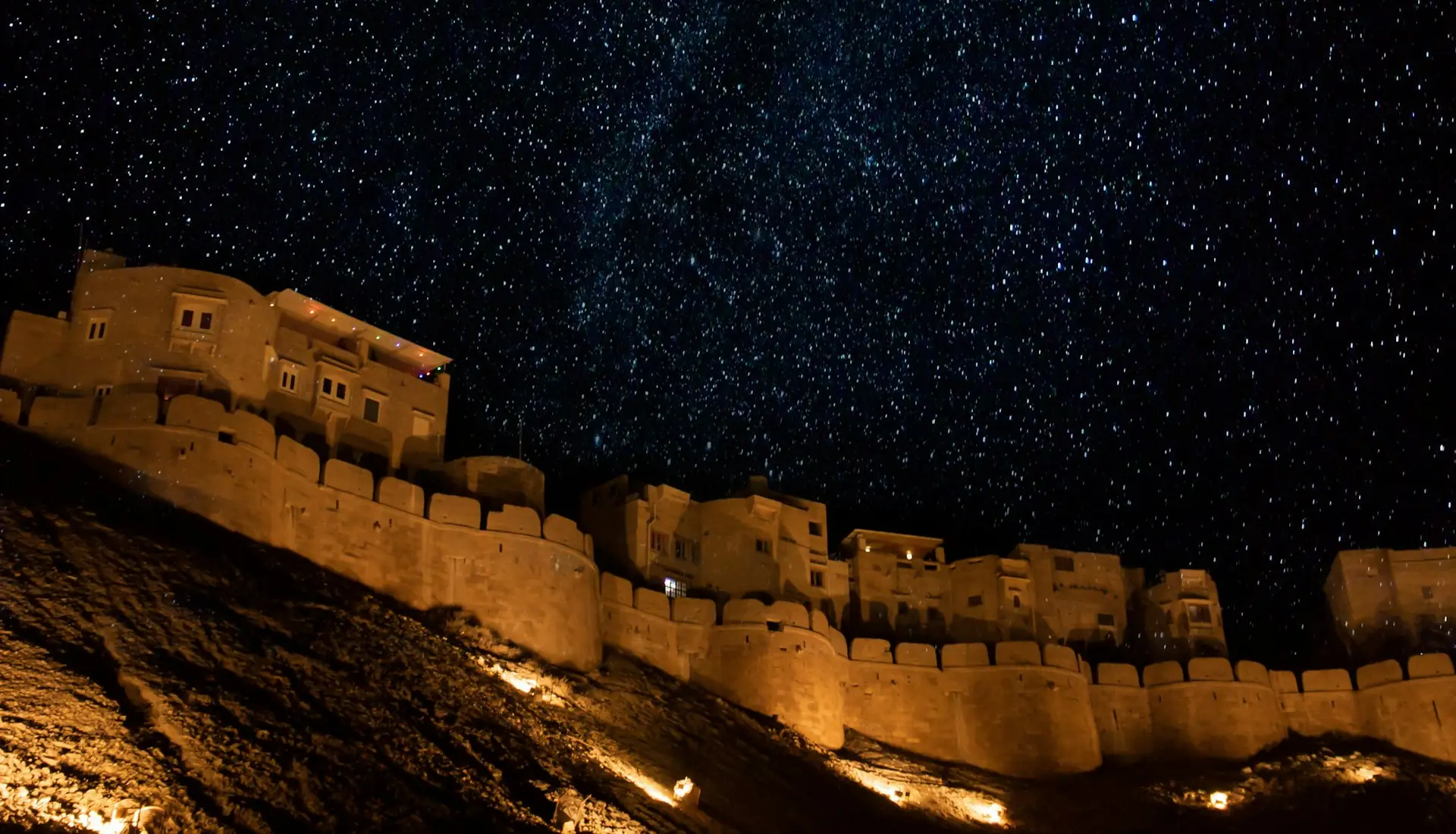 Jaisalmer Fort lit up at night under a starry sky