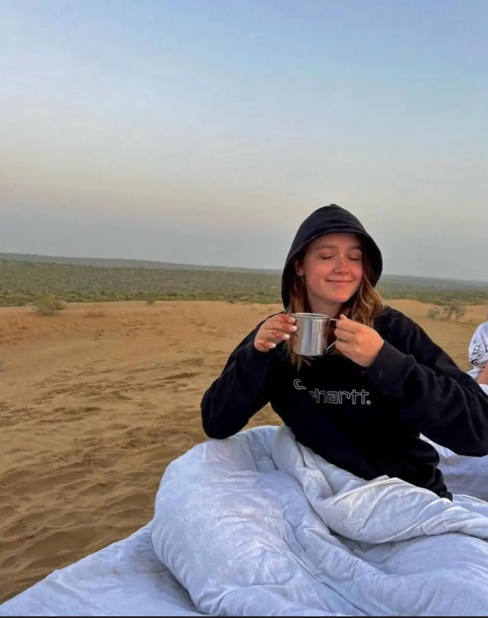 Traveller with morning tea on the dunes at sunrise